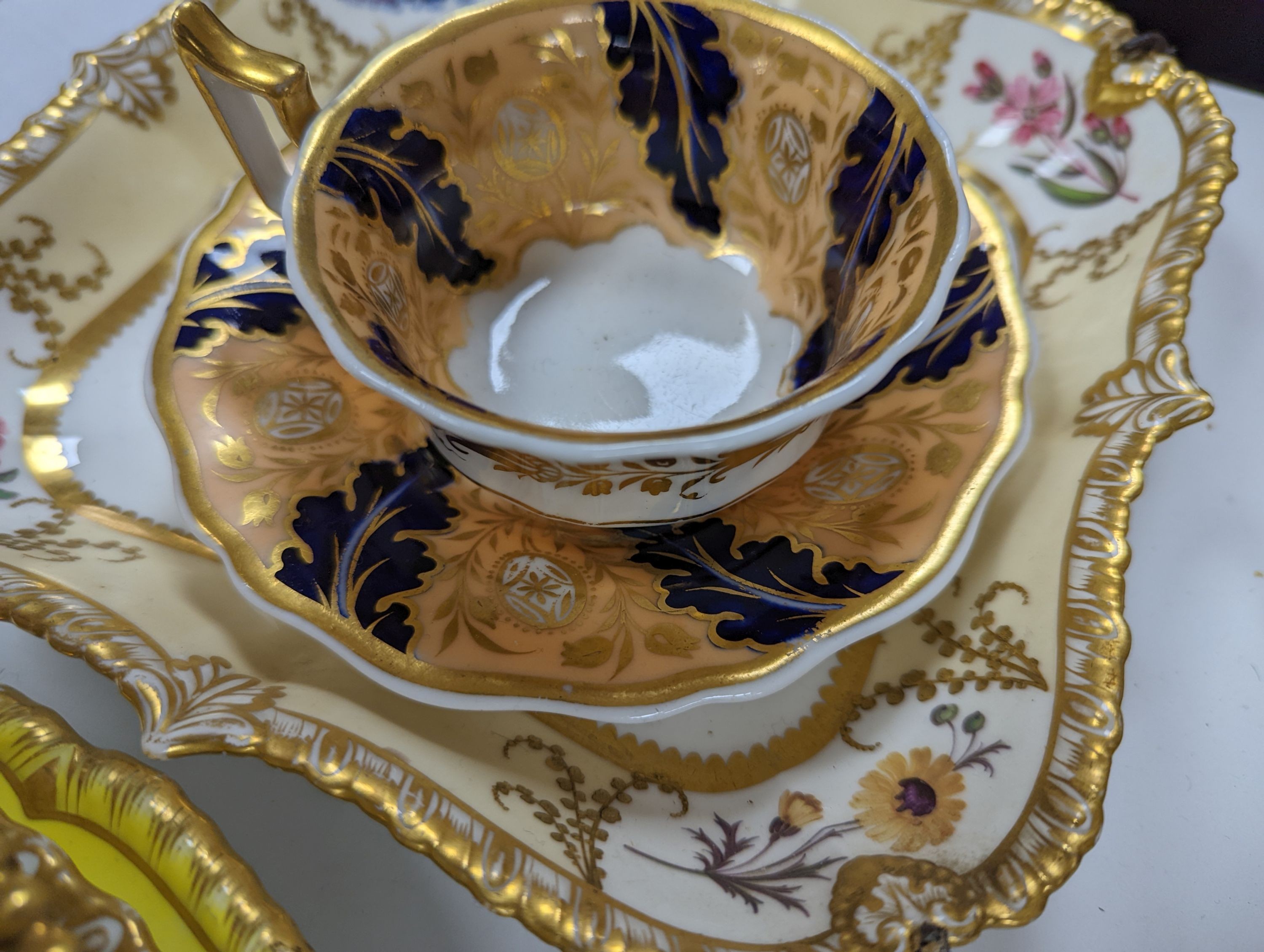 A small collection of Victorian porcelain tea cups and saucers and sundry dessert plates